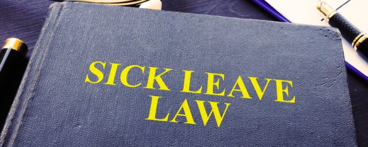 Sick leave law book and stethoscope