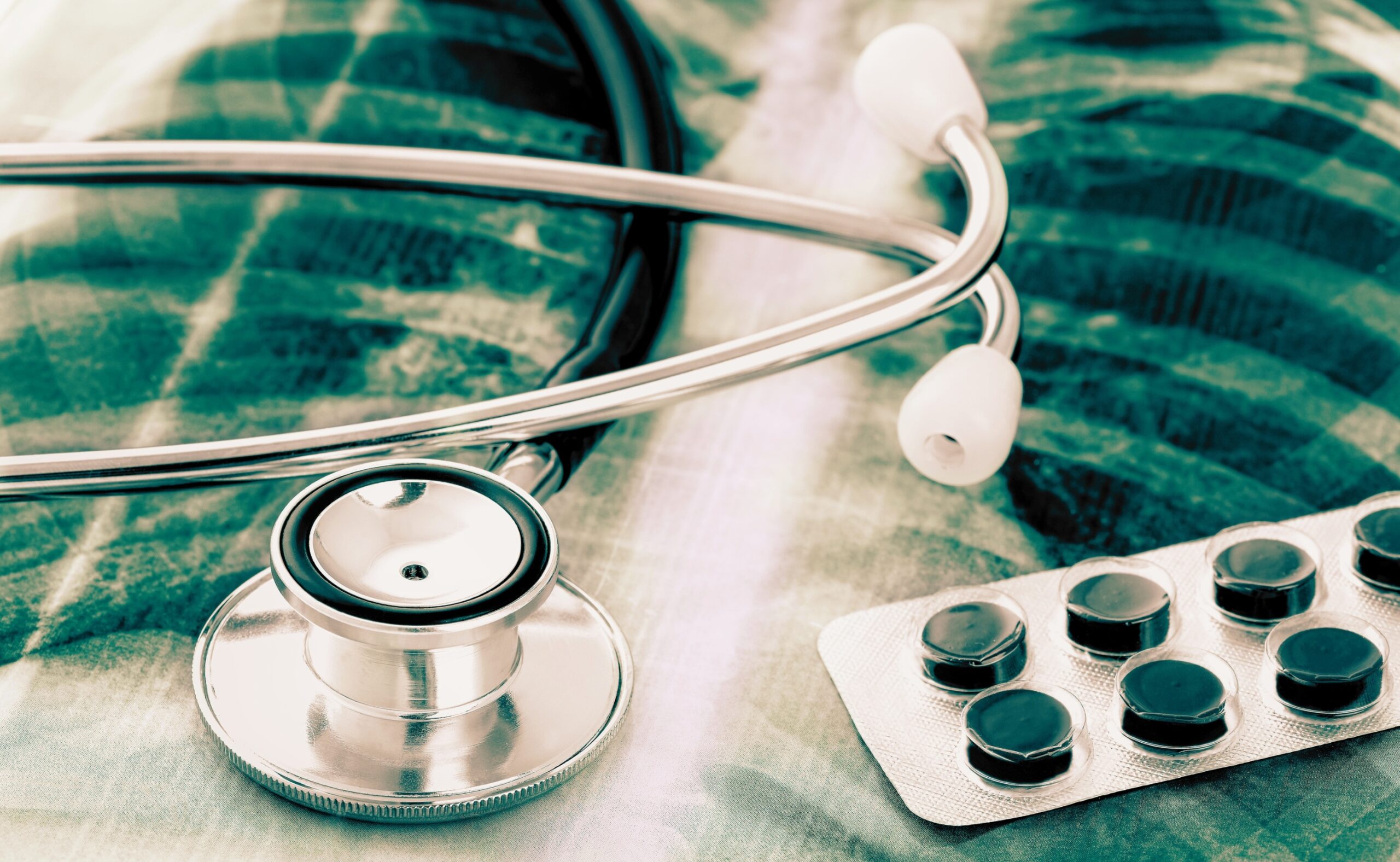 Pneumonia virus on an xray image with stethoscope and pills