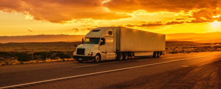 Semi-Truck on an Interstate Highway at Dusk with Cloudscape