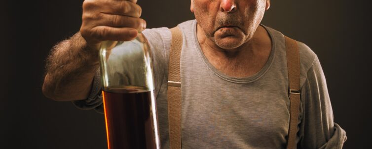 drunk old man holding a bottle