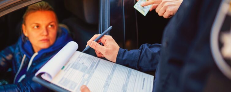 police patrol checking driver's license of female driver
