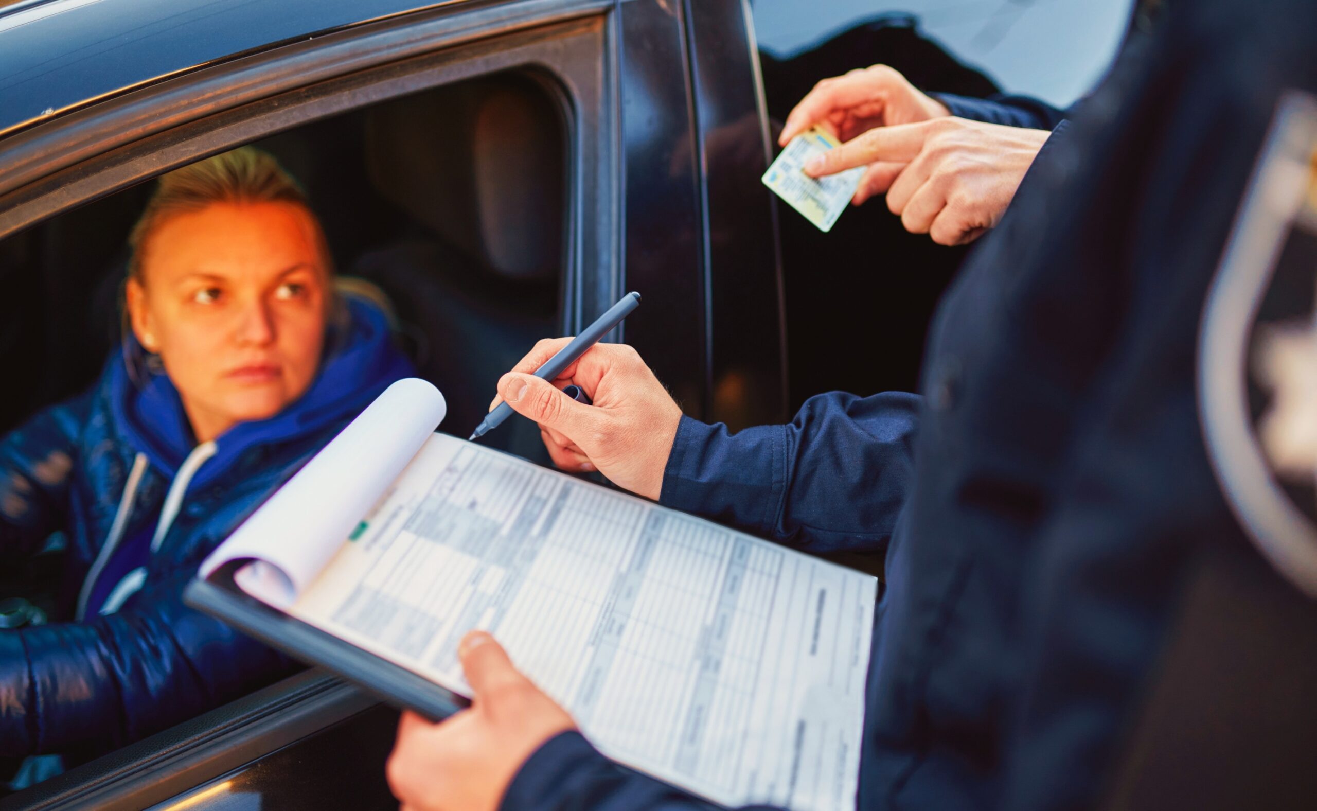 police patrol checking driver's license of female driver