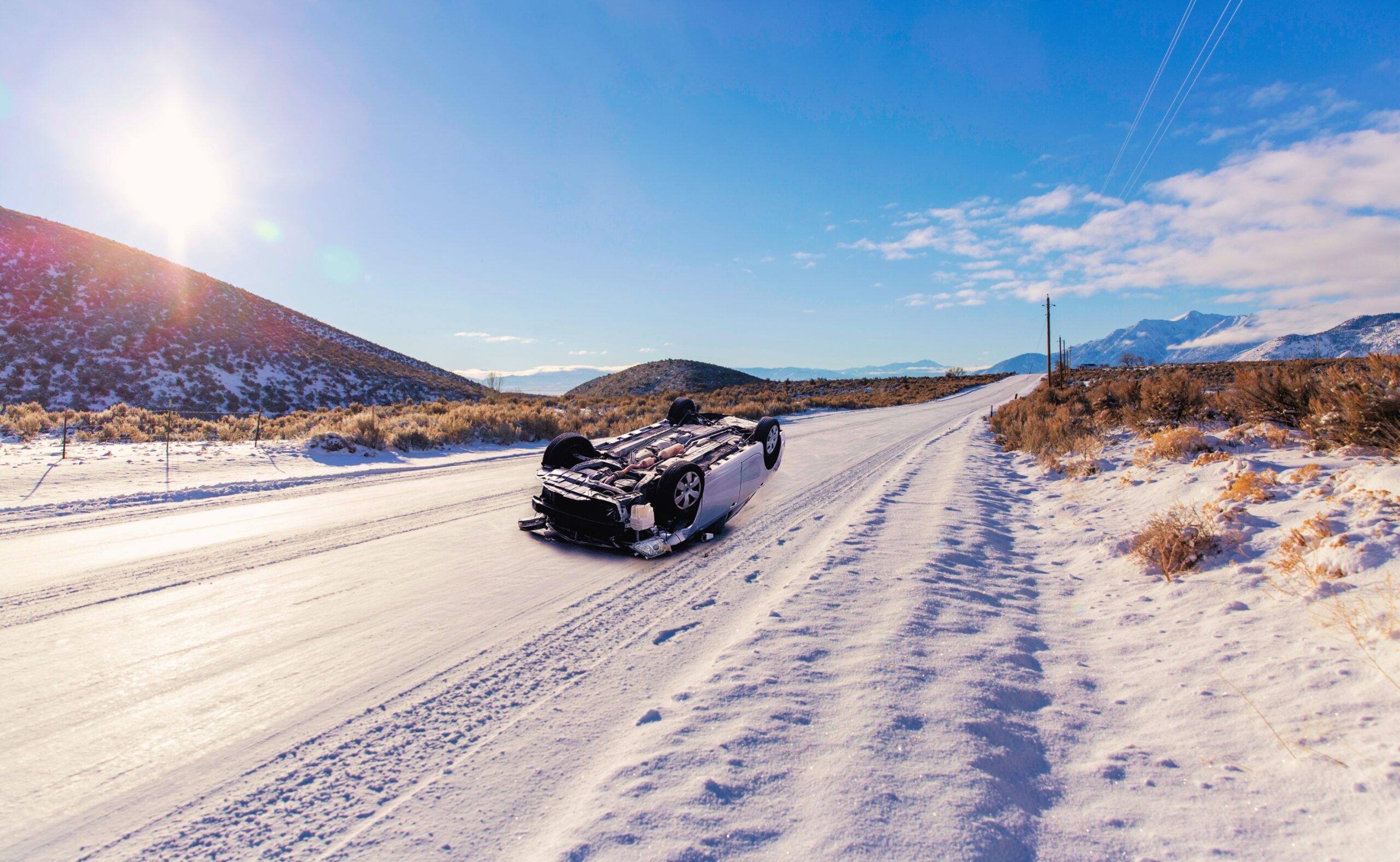 car rollover on a deserted snowy road