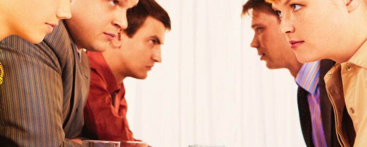 profiles of serious employees sitting in two rows and looking at each other
