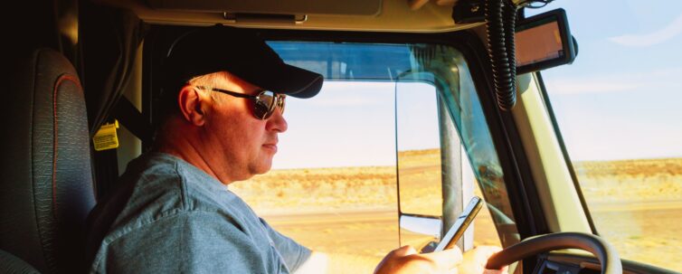 Man driving while holding a phone