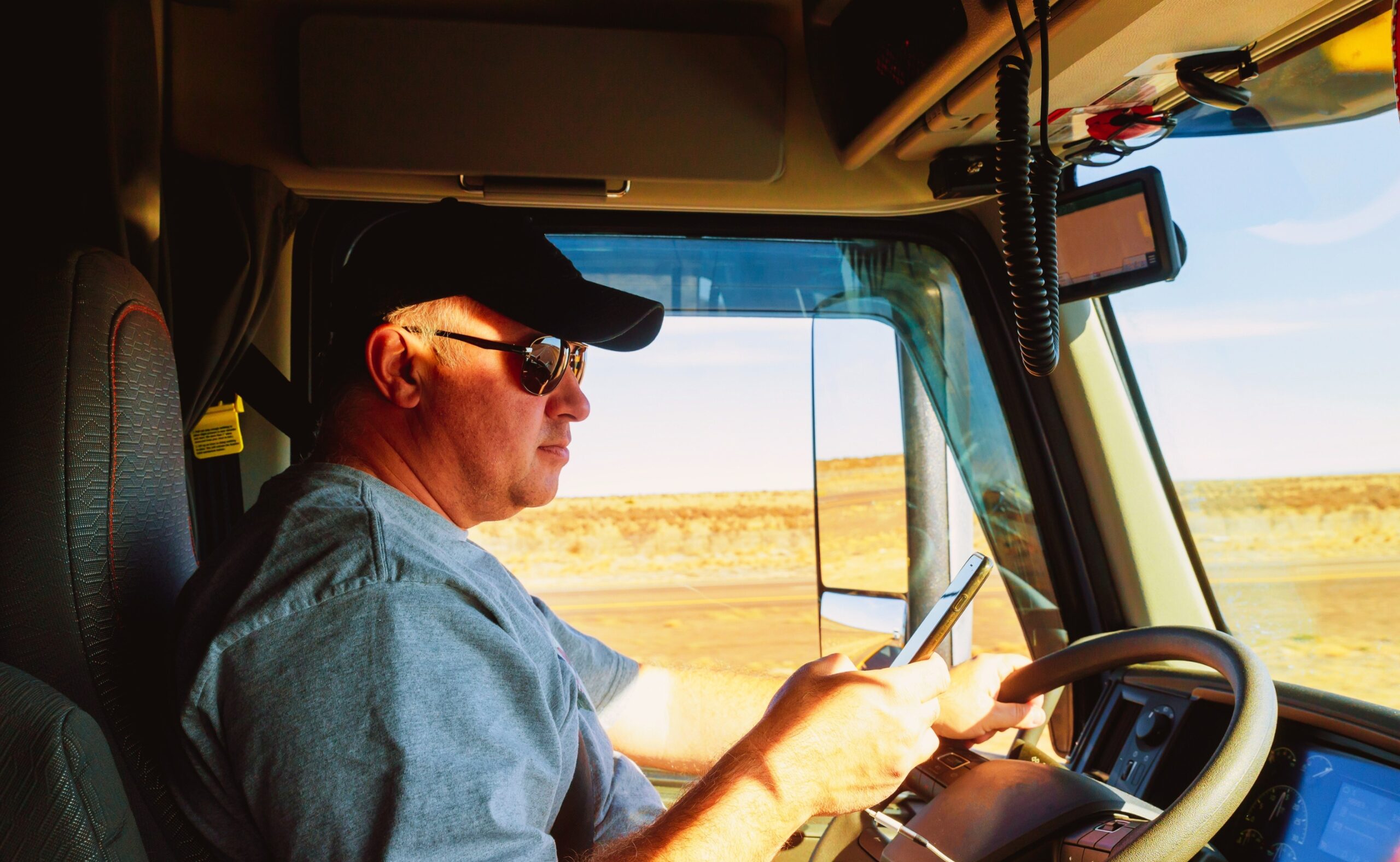 Man driving while holding a phone