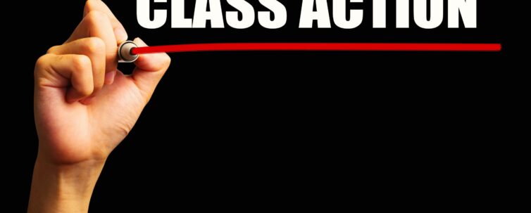 Hand is drawing a red line under the text class action with black background