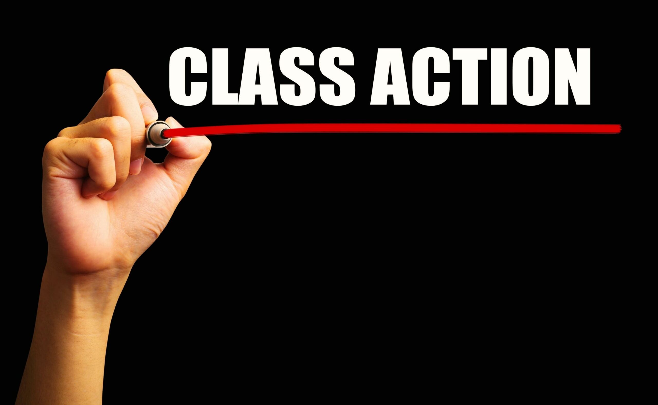 Hand is drawing a red line under the text class action with black background