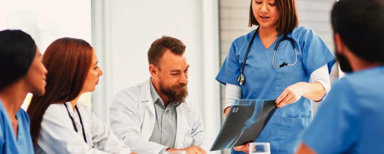 Shot of a group of medical practitioners analyzing x-rays in hospital boardroom