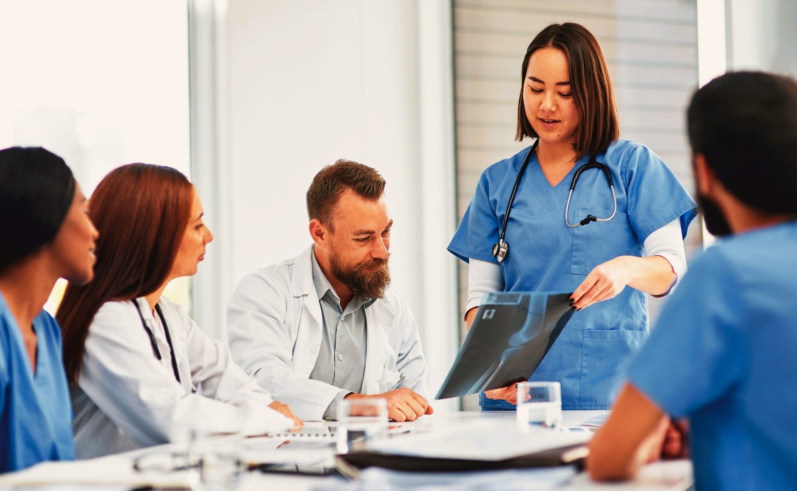 Shot of a group of medical practitioners analyzing x-rays in hospital boardroom