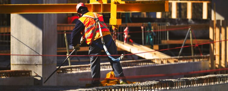 Construction site worker with safety harness hook
