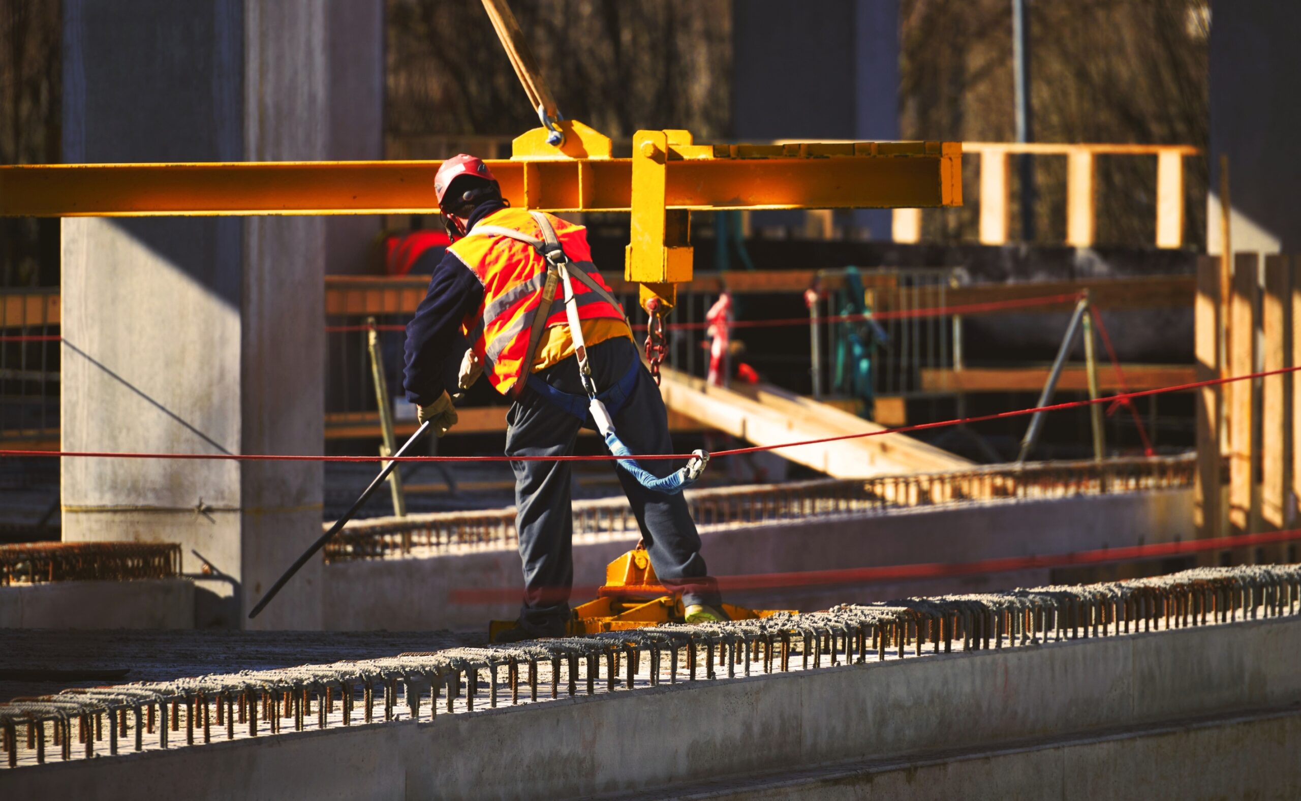 Construction site worker with safety harness hook