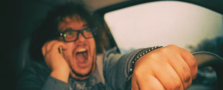 Distracted man driving and yelling on the phone