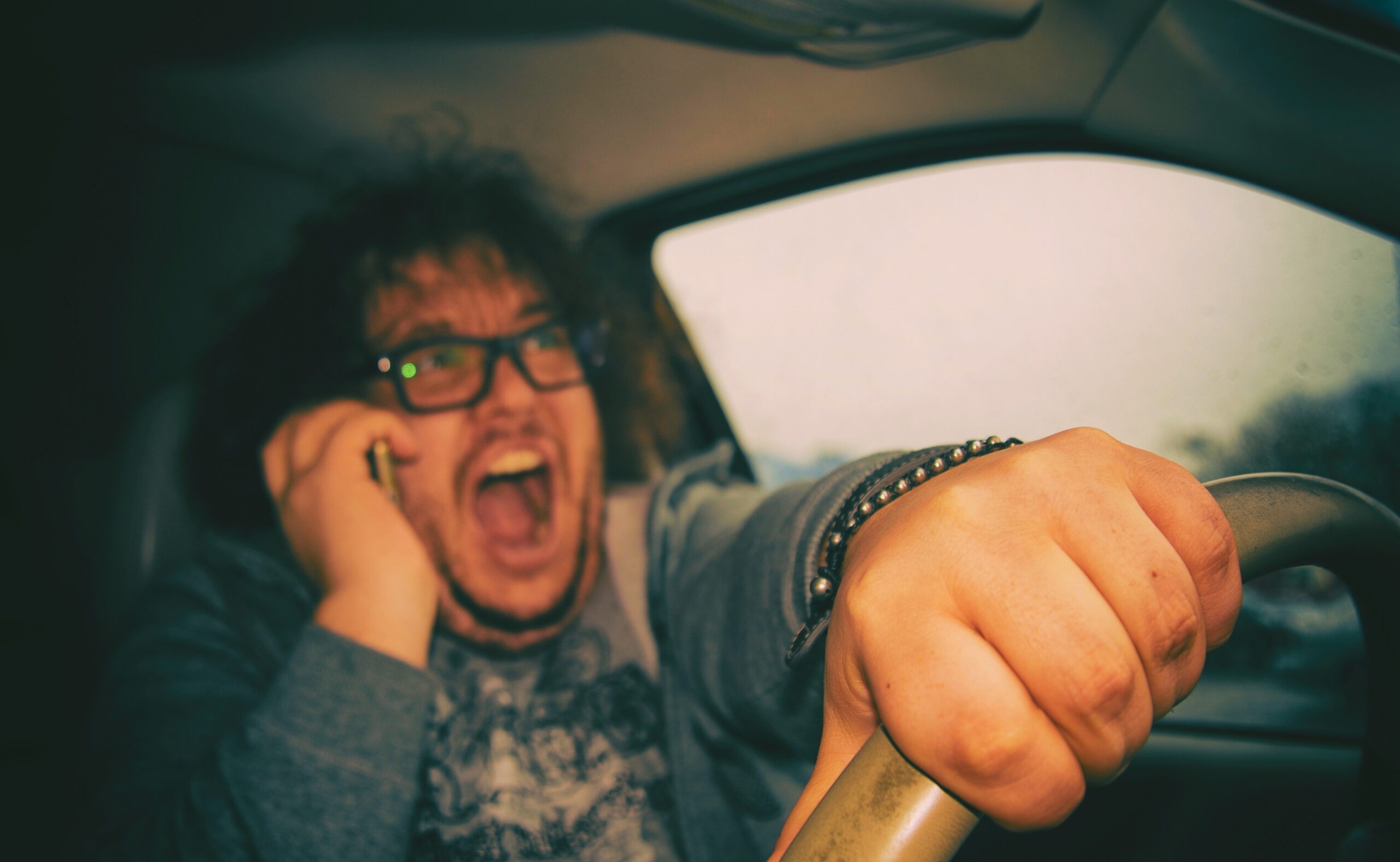 Distracted man driving and yelling on the phone