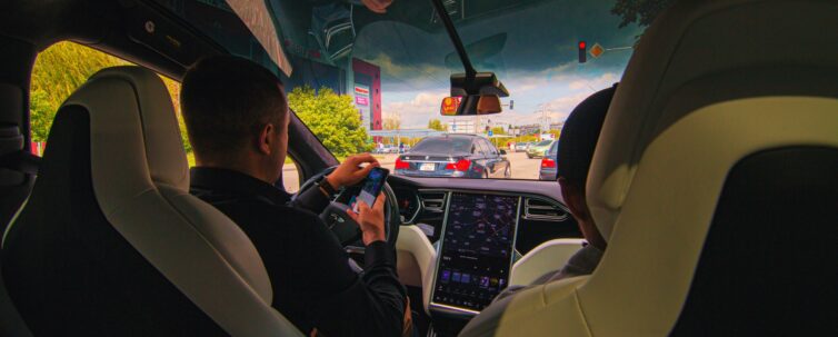 People inside a smart car, driver not doing smart thing.