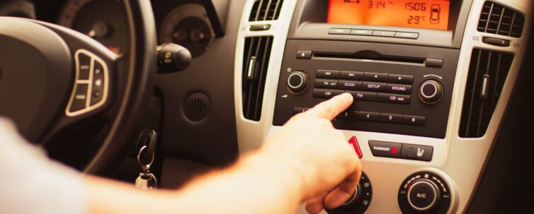 Man using car audio stereo system