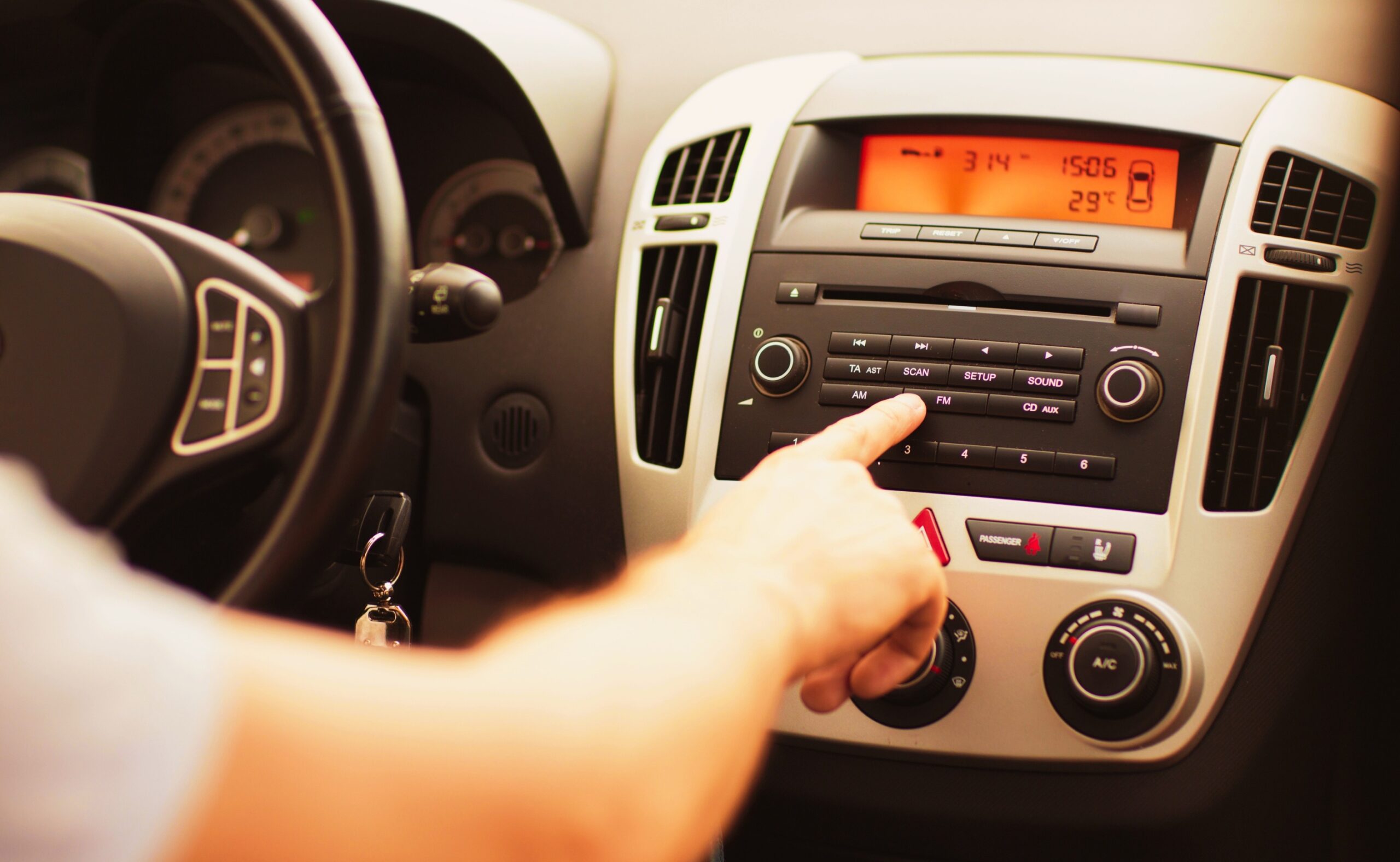 Man using car audio stereo system