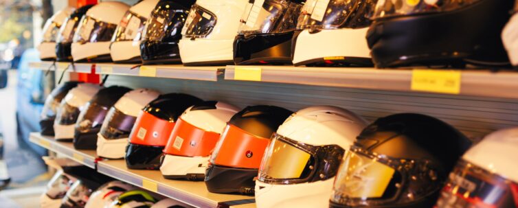 different helmets for sale in modern salon of motorcycle riding gear