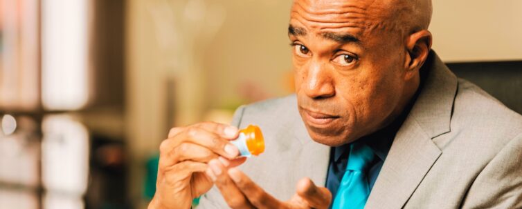 Worried man with an Opioid Prescription Bottle
