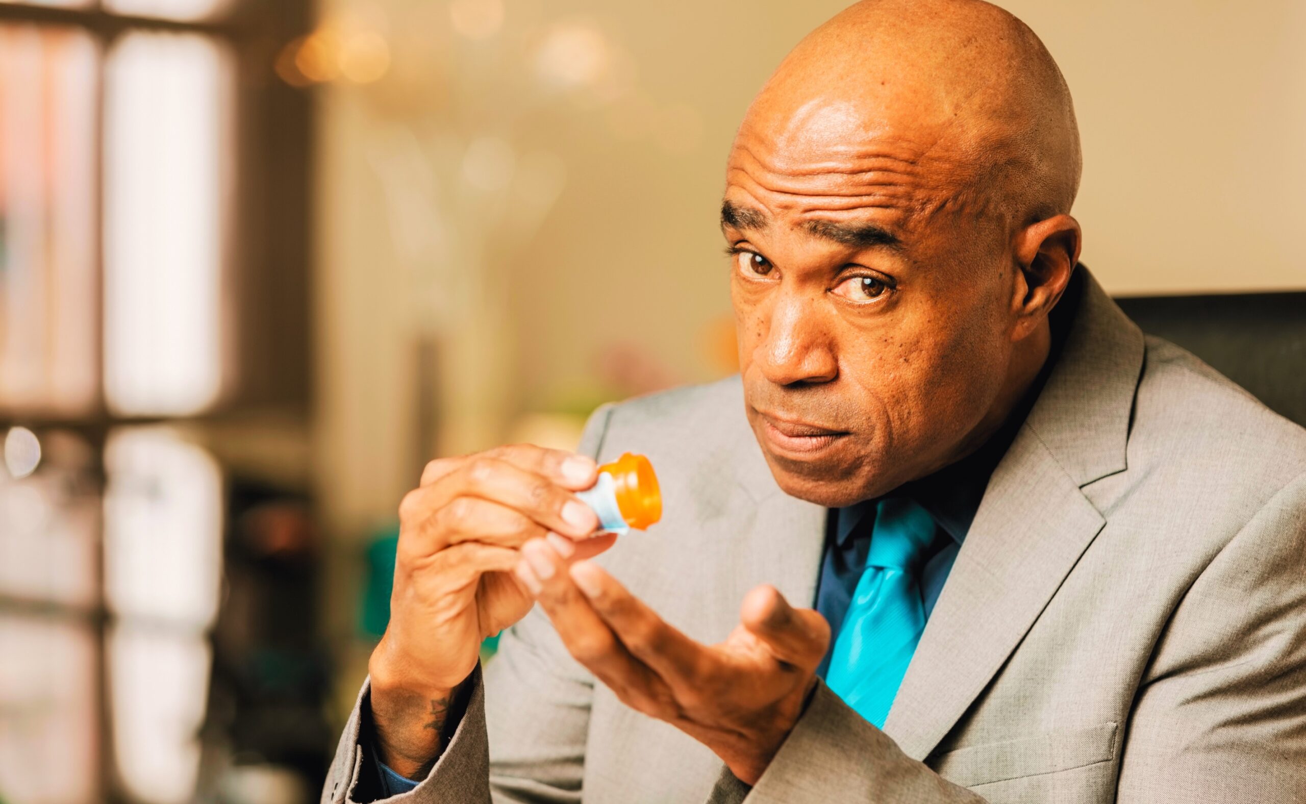 Worried man with an Opioid Prescription Bottle