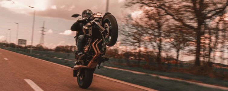 A Person Doing Wheelie using Motorcycle