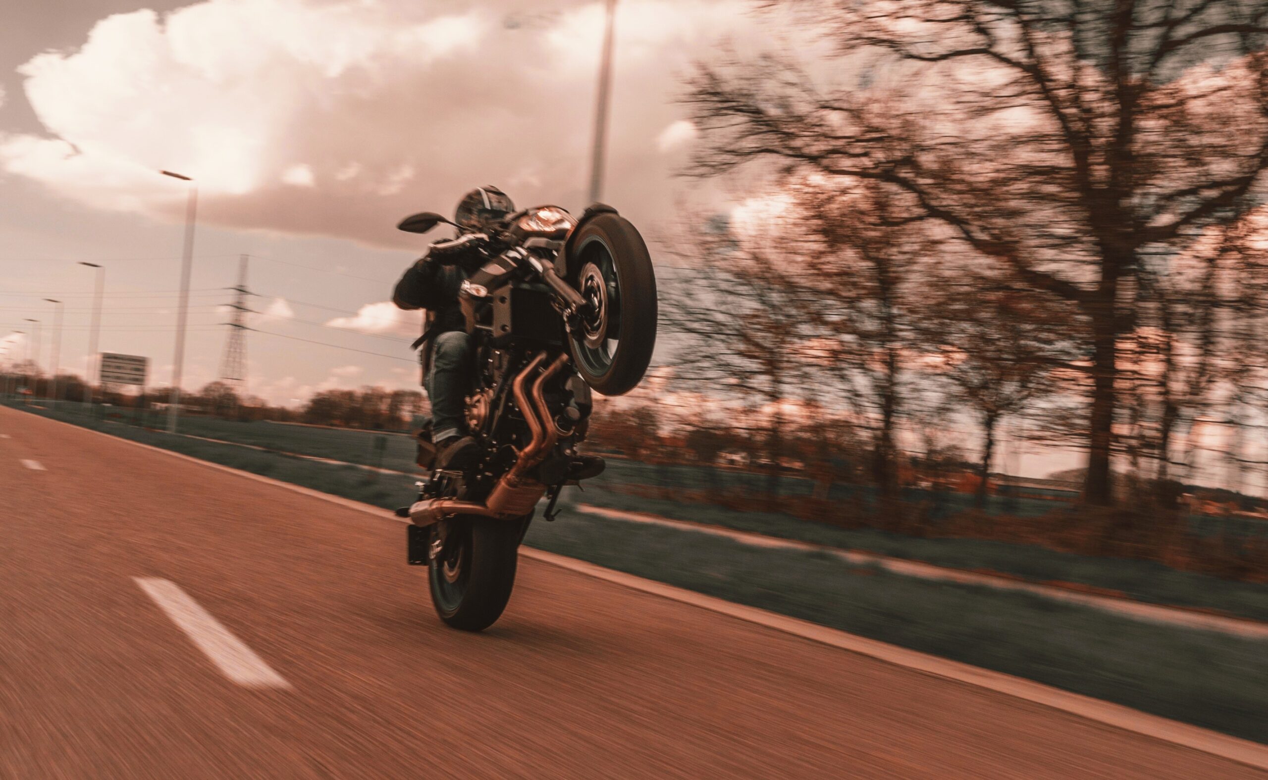 A Person Doing Wheelie using Motorcycle
