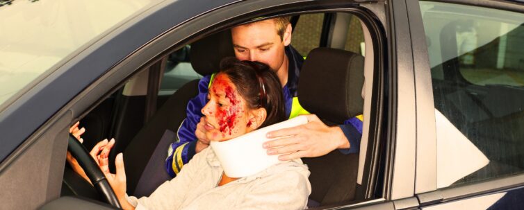 injured woman in car crash getting a whiplash neck brace