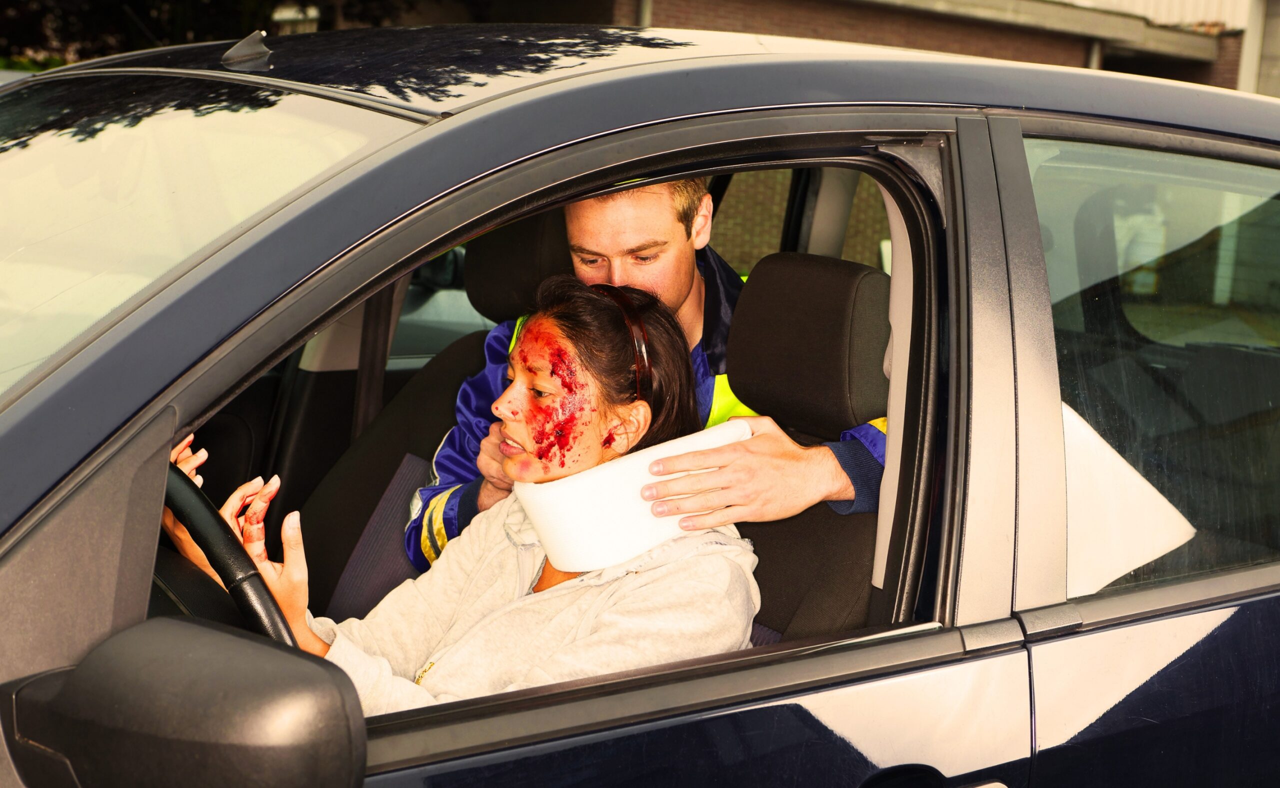 injured woman in car crash getting a whiplash neck brace