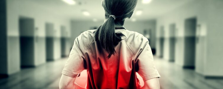 Nurse touching hurting back in black and white