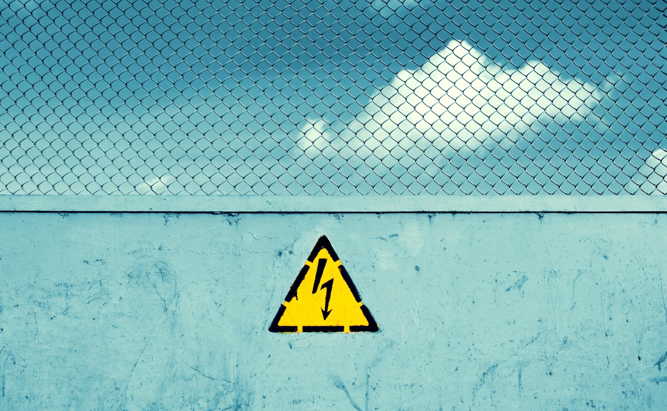 obstruction to mark unsafe, high voltage and grid. Danger of death. The sky behind the fence.