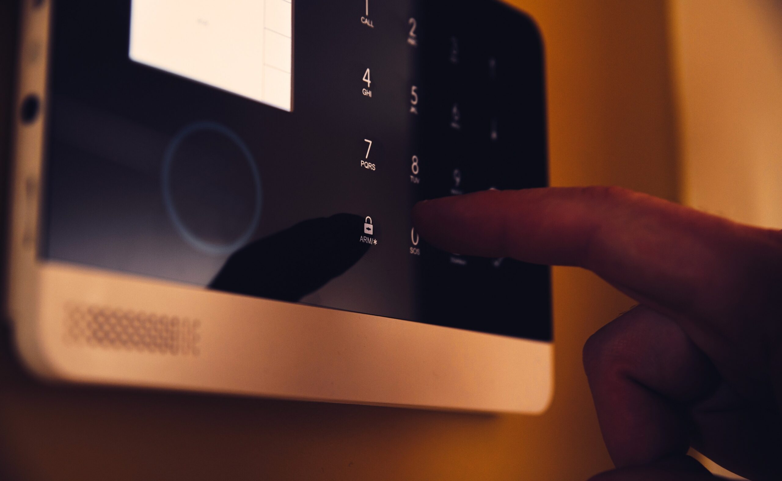 Man arming home security alarm, home alarm security control panel