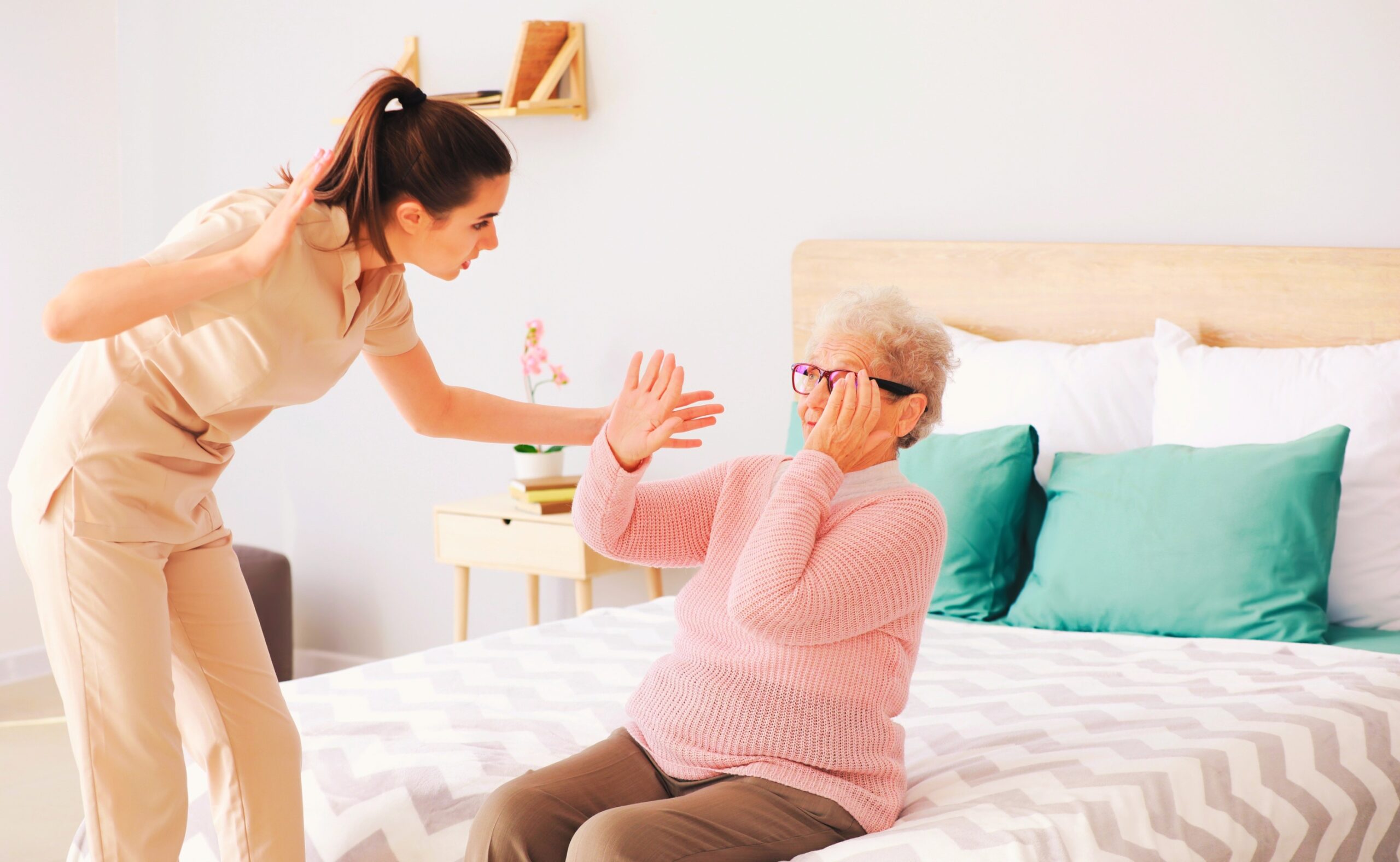 caregiver mistreating senior woman in nursing home