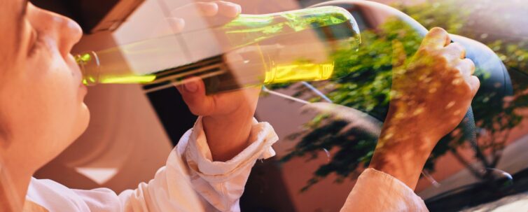 a woman drinking while driving