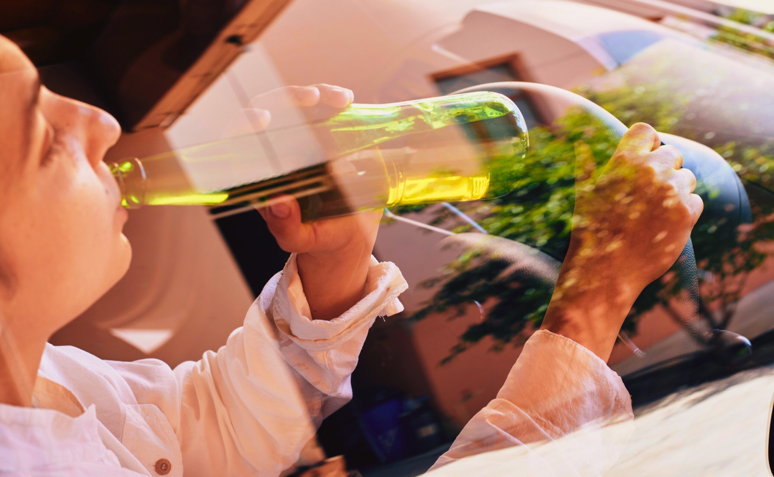 a woman drinking while driving
