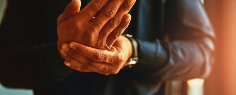 a man feeling numbness and pain in his hands