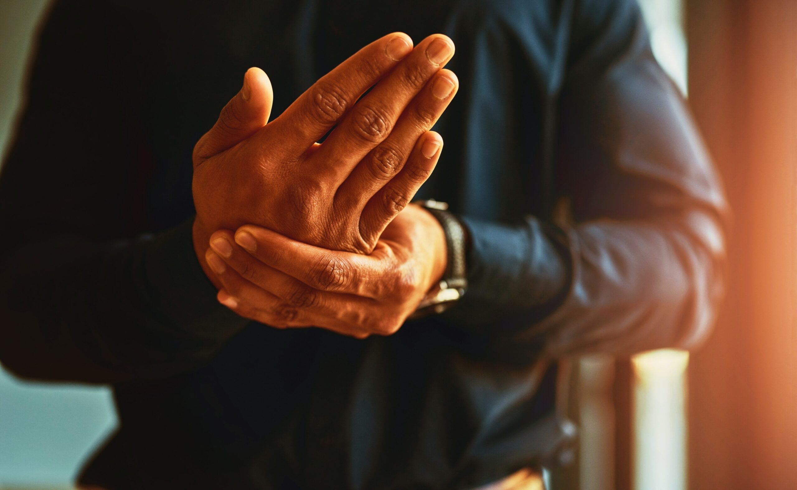 a man feeling numbness and pain in his hands