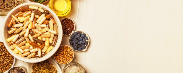 Capsules with dietary supplements. Ingredients for food supplements, minerals, oils and herbs in plates