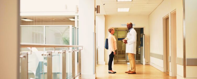 Male doctor talking to a female patient in the hospital
