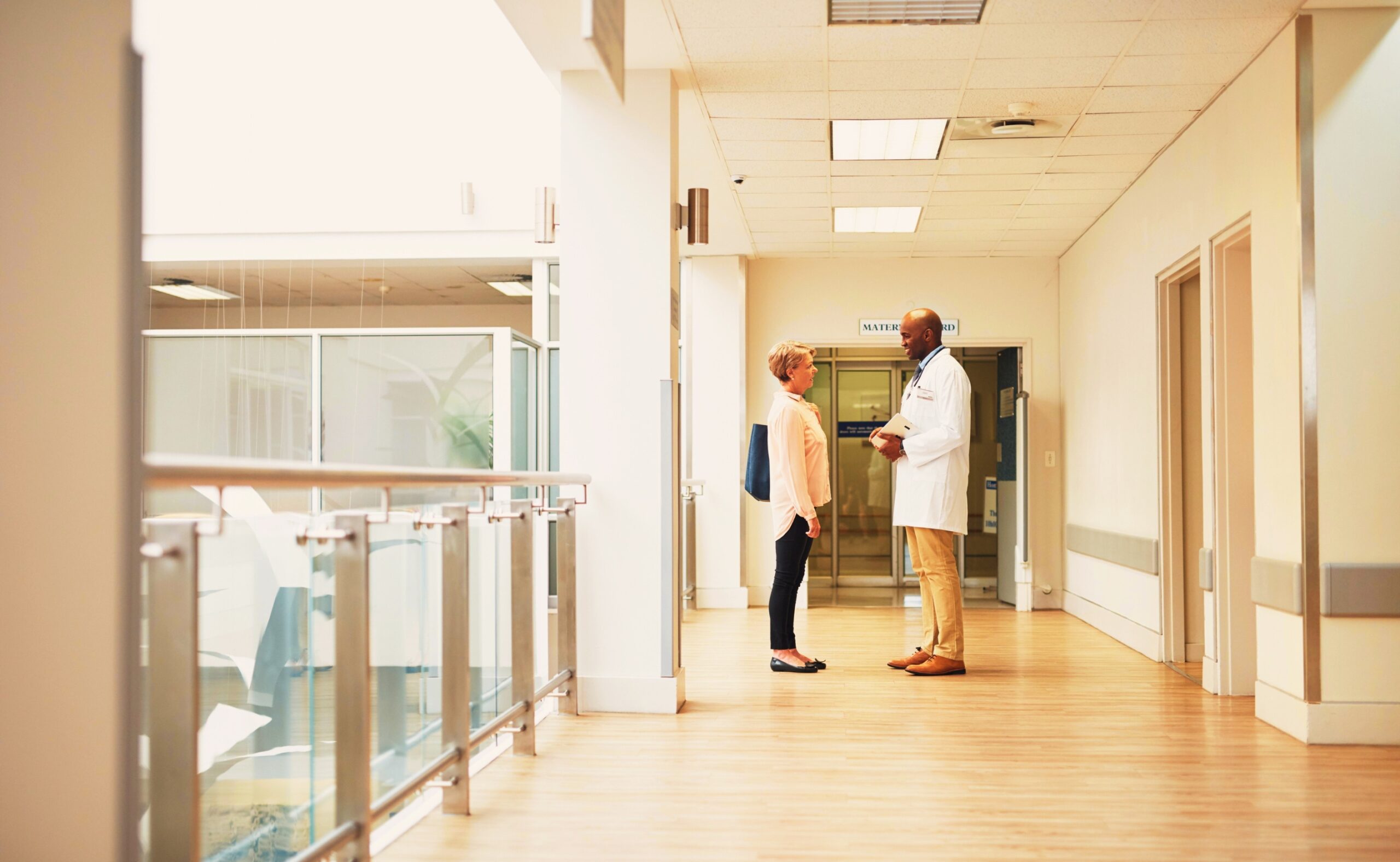 Male doctor talking to a female patient in the hospital