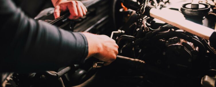 Auto mechanic working on the engine