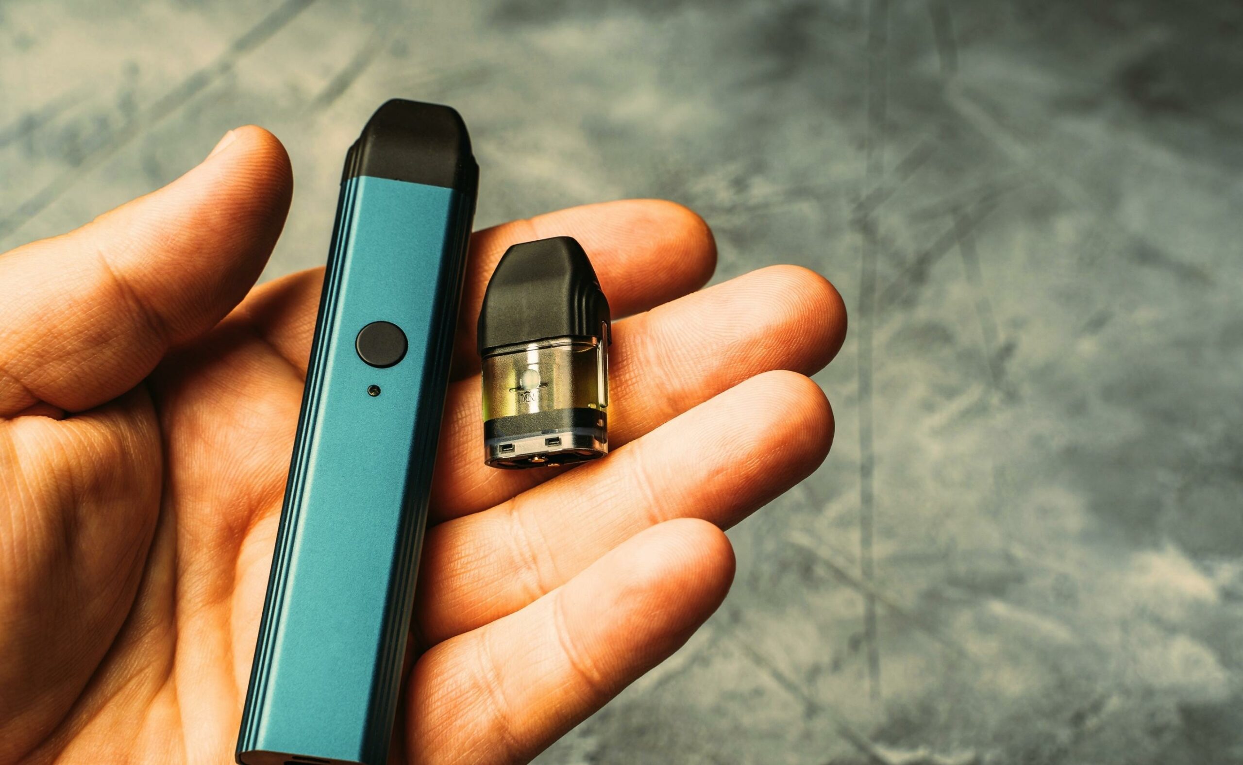 Vape pod in male hand or pod mod with changeable cartridge's