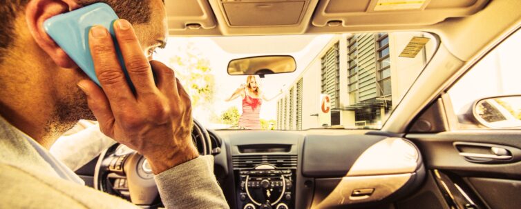 Driver talking on the phone, distracted about to hit a woman crossing the street