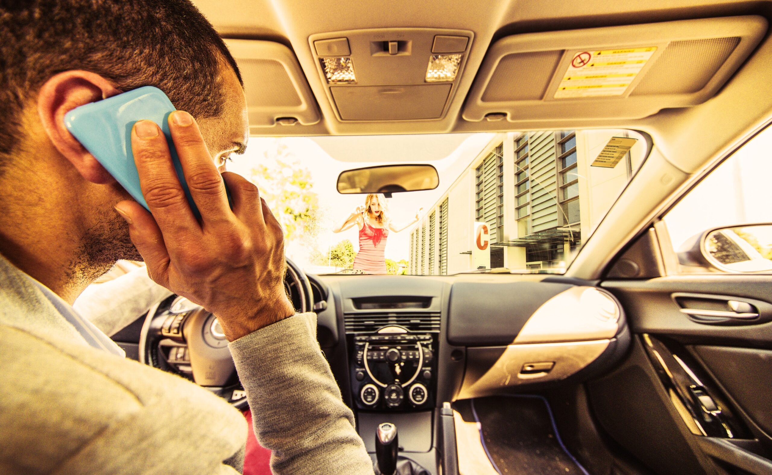 Driver talking on the phone, distracted about to hit a woman crossing the street