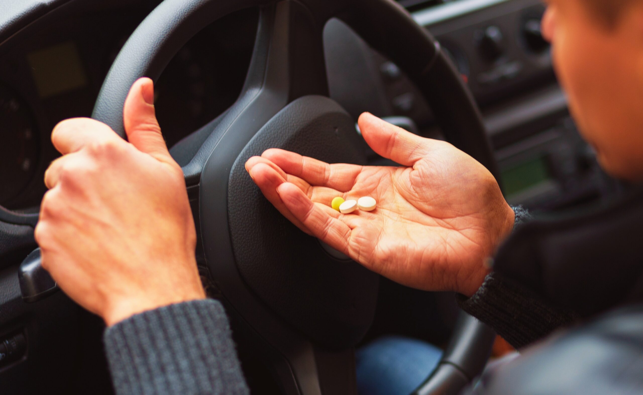 Man taking drugs inside a car