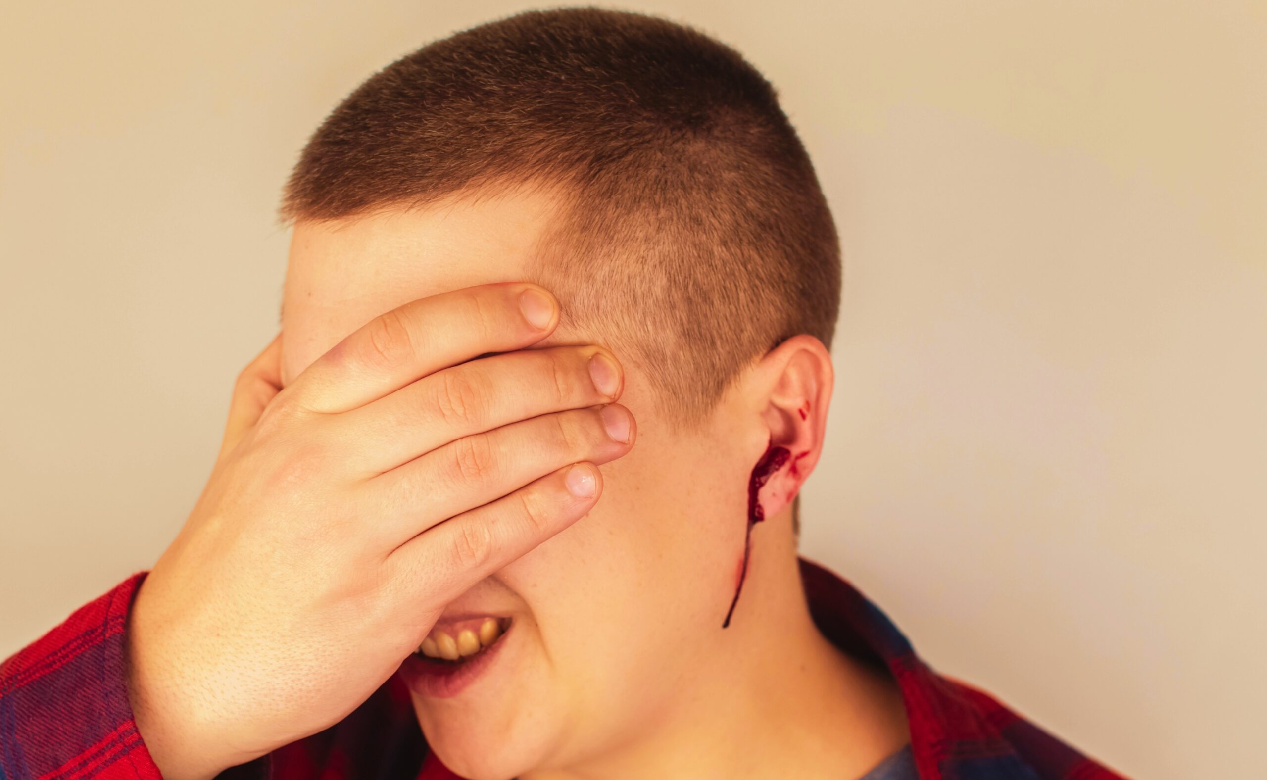 A man whose ear is bleeding vascular rapture, damage to the tympanic membrane