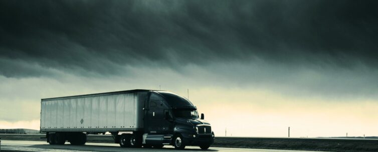 Sideview of semi truck speeding down the highway