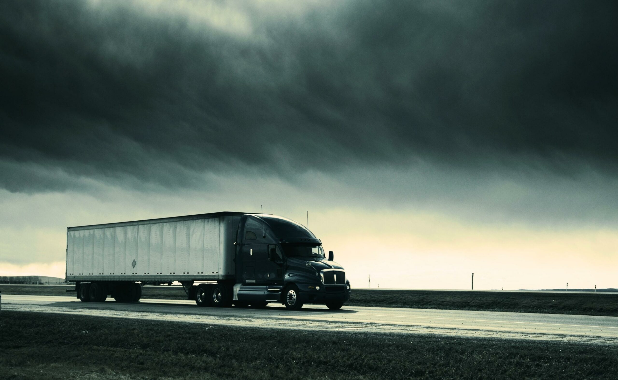 Sideview of semi truck speeding down the highway