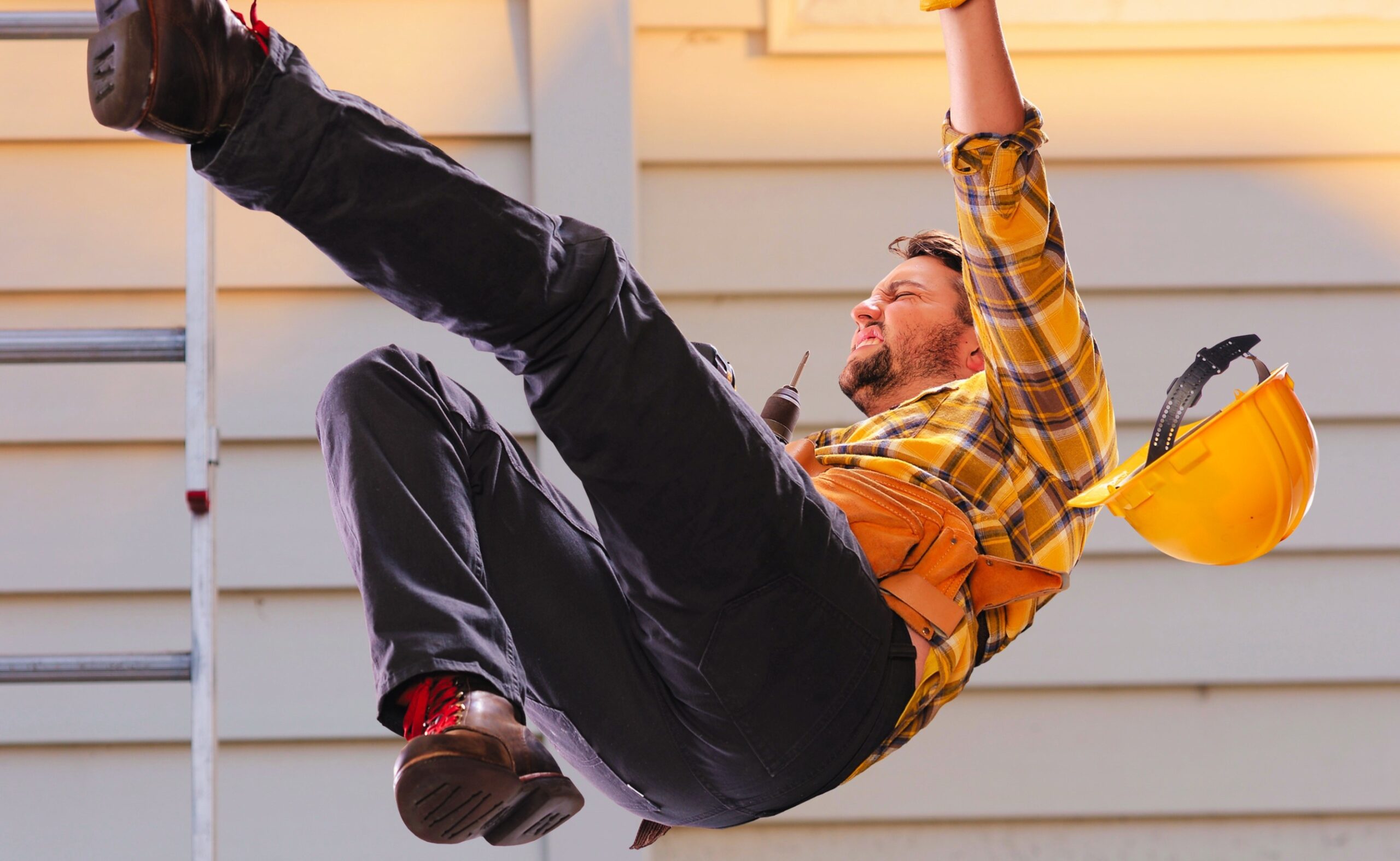 worker falling from a ladder onto floor