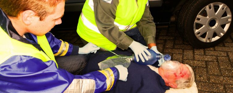 paramedics helping a car crash victim with an oxygen mask