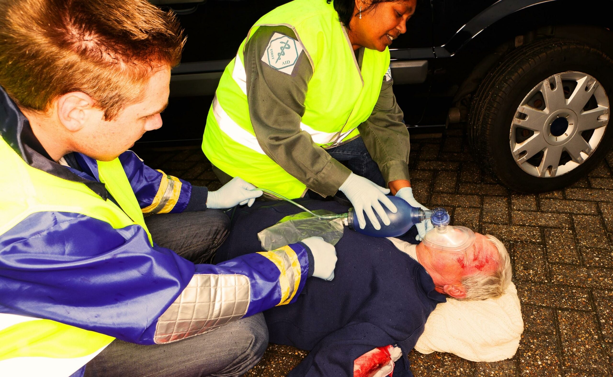 paramedics helping a car crash victim with an oxygen mask